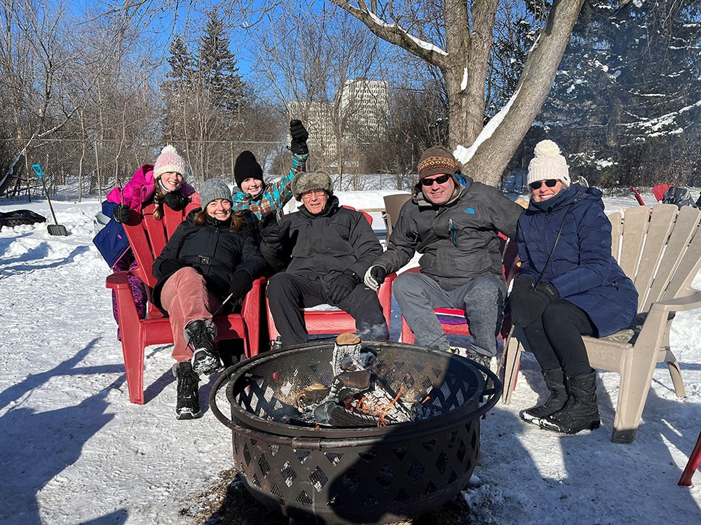 People enjoying outdoor fire pits in the winter.